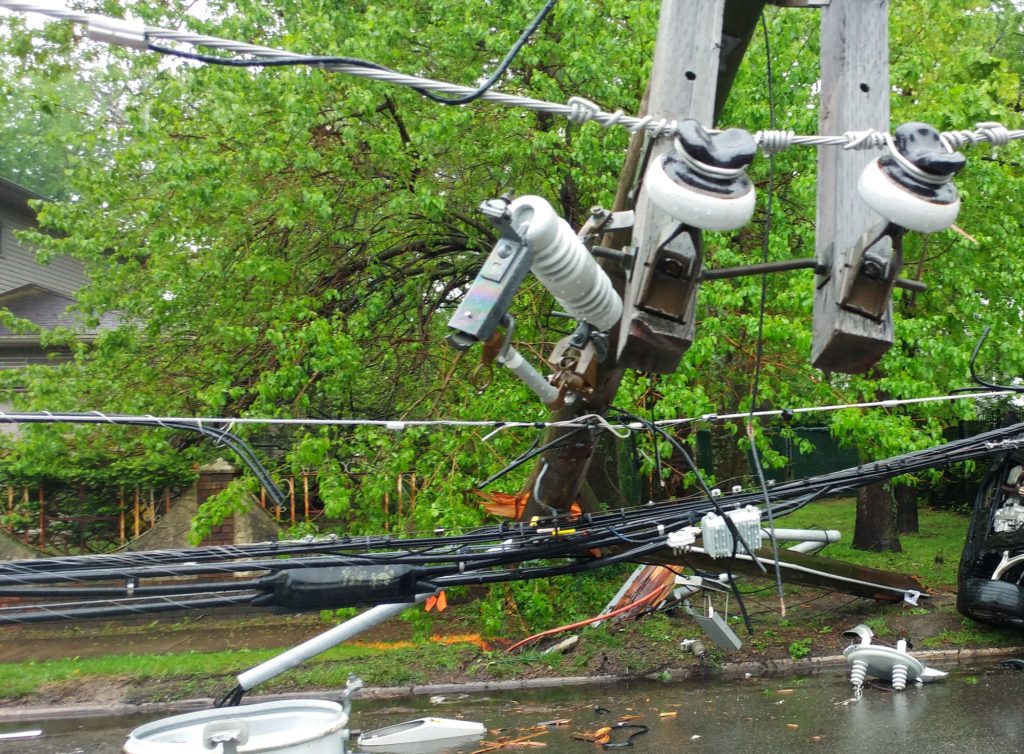 Storm damaged electric transformer on a pole and a tree damaged